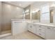Well lit bathroom featuring a large shower with beige tiling, and dual vanity with white cabinets at 19522 Wood Farm Pl, Westfield, IN 46074