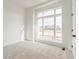 Bright bedroom showcasing a large window offering an exterior view of the neighborhood at 19522 Wood Farm Pl, Westfield, IN 46074