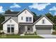 Charming two-story home boasts a modern farmhouse design with stone accents and a well-manicured lawn at 19522 Wood Farm Pl, Westfield, IN 46074