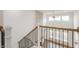 Foyer showcasing a stone fireplace, wrought iron railing, and an open concept layout at 19522 Wood Farm Pl, Westfield, IN 46074