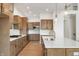 Well-equipped kitchen with an island, granite countertops, and modern appliances, perfect for culinary enthusiasts at 19522 Wood Farm Pl, Westfield, IN 46074