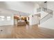 Open-concept living space with a kitchen, a staircase, and bright wood floors, ideal for entertaining and everyday living at 19522 Wood Farm Pl, Westfield, IN 46074