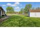The spacious backyard boasts a well-maintained lawn, wood fence, and convenient storage shed at 250 3 Notch Ln, Bargersville, IN 46106