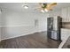 Modern kitchen featuring stainless steel refrigerator, hardwood floors, and pantry space at 250 3 Notch Ln, Bargersville, IN 46106