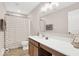 Bright bathroom featuring a modern vanity, decorative mirror and a shower with stylish patterned curtain at 279 Commodore Dr, Pittsboro, IN 46167
