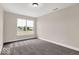 Well-lit bedroom with neutral paint, trim, and plush gray carpet at 279 Commodore Dr, Pittsboro, IN 46167