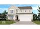 Charming two-story home with a two-car garage, inviting front porch, and neutral color palette at 279 Commodore Dr, Pittsboro, IN 46167
