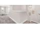 Bright hallway with neutral paint and carpet, featuring a peek into the playroom area at 279 Commodore Dr, Pittsboro, IN 46167