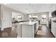 Bright, open-concept kitchen featuring an island with seating, stainless appliances, and hardwood flooring at 279 Commodore Dr, Pittsboro, IN 46167