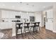 Modern kitchen with stainless appliances, white cabinets, tile backsplash, and an eat-in island at 279 Commodore Dr, Pittsboro, IN 46167