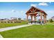 Community picnic pavilion featuring picnic tables and views of the surrounding green space and homes at 279 Commodore Dr, Pittsboro, IN 46167