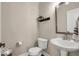 Cozy powder room featuring modern fixtures, a pedestal sink, and a well-lit mirror at 279 Commodore Dr, Pittsboro, IN 46167