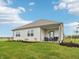 Charming backyard featuring a covered patio, well-manicured lawn, and lush landscaping at 30 Benfield Dr, Whiteland, IN 46184