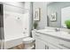 Bright bathroom featuring white cabinets, a bathtub with shower, and modern fixtures at 30 Benfield Dr, Whiteland, IN 46184