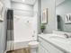 Bright bathroom featuring white cabinets, a bathtub with shower, and modern fixtures at 30 Benfield Dr, Whiteland, IN 46184
