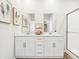 Bright bathroom featuring double sink vanity with white cabinets and decorative mirrors at 30 Benfield Dr, Whiteland, IN 46184