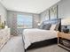 Bright bedroom featuring a comfortable bed, stylish decor, and natural light from the window at 30 Benfield Dr, Whiteland, IN 46184