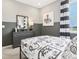 Cozy bedroom featuring gray walls, white and black bedding, and window with striped curtains at 30 Benfield Dr, Whiteland, IN 46184