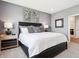Elegant bedroom featuring a comfortable bed, stylish lamps, and neutral decor at 30 Benfield Dr, Whiteland, IN 46184