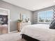 Bright bedroom featuring a comfortable bed, dresser, and a view into the dining room at 30 Benfield Dr, Whiteland, IN 46184