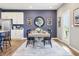 Chic dining room with modern decor, a wooden table, and black chairs, complemented by a stainless refrigerator at 30 Benfield Dr, Whiteland, IN 46184