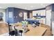 Elegant dining room with a wood table, black chairs, and stylish white kitchen in the background at 30 Benfield Dr, Whiteland, IN 46184