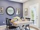 Cozy dining area features a modern table setting, stylish decor, and natural light from the backyard at 30 Benfield Dr, Whiteland, IN 46184