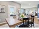 Bright dining area with table, seating, backyard door and living room, bathed in natural light at 30 Benfield Dr, Whiteland, IN 46184