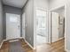Inviting foyer with wood flooring leading to a sunlit bedroom at 30 Benfield Dr, Whiteland, IN 46184