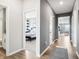 Bright hallway with wood floors leads to a bathroom and bedroom with stylish decor at 30 Benfield Dr, Whiteland, IN 46184