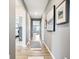 Spacious hallway featuring wood floors, neutral walls, and decorative artwork at 30 Benfield Dr, Whiteland, IN 46184