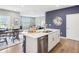 Kitchen showcasing an island with seating, stainless steel sink, and view into the living area at 30 Benfield Dr, Whiteland, IN 46184