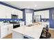 Bright kitchen with white cabinets, stainless steel appliances, and a large island with breakfast bar at 30 Benfield Dr, Whiteland, IN 46184