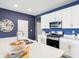 Well-lit kitchen with stainless steel appliances, white cabinets, and island with breakfast bar at 30 Benfield Dr, Whiteland, IN 46184
