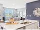Bright kitchen with a center island, stainless steel sink, and open to the living room at 30 Benfield Dr, Whiteland, IN 46184