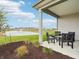 Covered patio overlooking a pond and manicured landscaping offers tranquil outdoor space at 30 Benfield Dr, Whiteland, IN 46184
