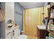 Cozy bathroom with blue walls, yellow shower curtain and decorative ladder shelf at 303 W 7Th St, Lapel, IN 46051