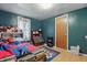 Bright bedroom with blue accent wall, closet, door and hardwood floors at 303 W 7Th St, Lapel, IN 46051