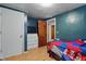 Cozy bedroom with blue accent wall, dresser, television, and hardwood floors at 303 W 7Th St, Lapel, IN 46051