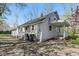 A house featuring vinyl siding, a covered back porch, and black trash receptacles at 303 W 7Th St, Lapel, IN 46051