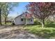Charming home featuring a cozy front porch and lush flowering tree in the front yard at 303 W 7Th St, Lapel, IN 46051