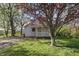 Inviting home with a manicured lawn, mature trees, and a charming facade at 303 W 7Th St, Lapel, IN 46051