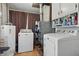 Functional laundry room features matching washer and dryer, water heater and storage cabinets at 303 W 7Th St, Lapel, IN 46051