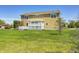 The home's backyard showcases a well-kept lawn and a charming deck with a pergola, perfect for outdoor living at 3147 Winings Ln, Carmel, IN 46074