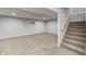 Finished basement with carpeted floor, bright lighting, and stairway to upper level at 3147 Winings Ln, Carmel, IN 46074