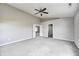 The large bedroom has gray walls, carpet flooring, access to ensuite, and a ceiling fan at 3147 Winings Ln, Carmel, IN 46074