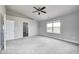 The primary bedroom features a ceiling fan, carpet flooring, and large windows at 3147 Winings Ln, Carmel, IN 46074