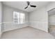 Comfortable bedroom showcasing neutral carpet, a ceiling fan, and natural lighting at 3147 Winings Ln, Carmel, IN 46074