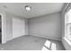 A cozy bedroom provides a closet, neutral walls, soft carpet and a window for natural light at 3147 Winings Ln, Carmel, IN 46074