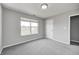 A cozy bedroom offers neutral walls, soft carpet and a window for lots of natural light at 3147 Winings Ln, Carmel, IN 46074